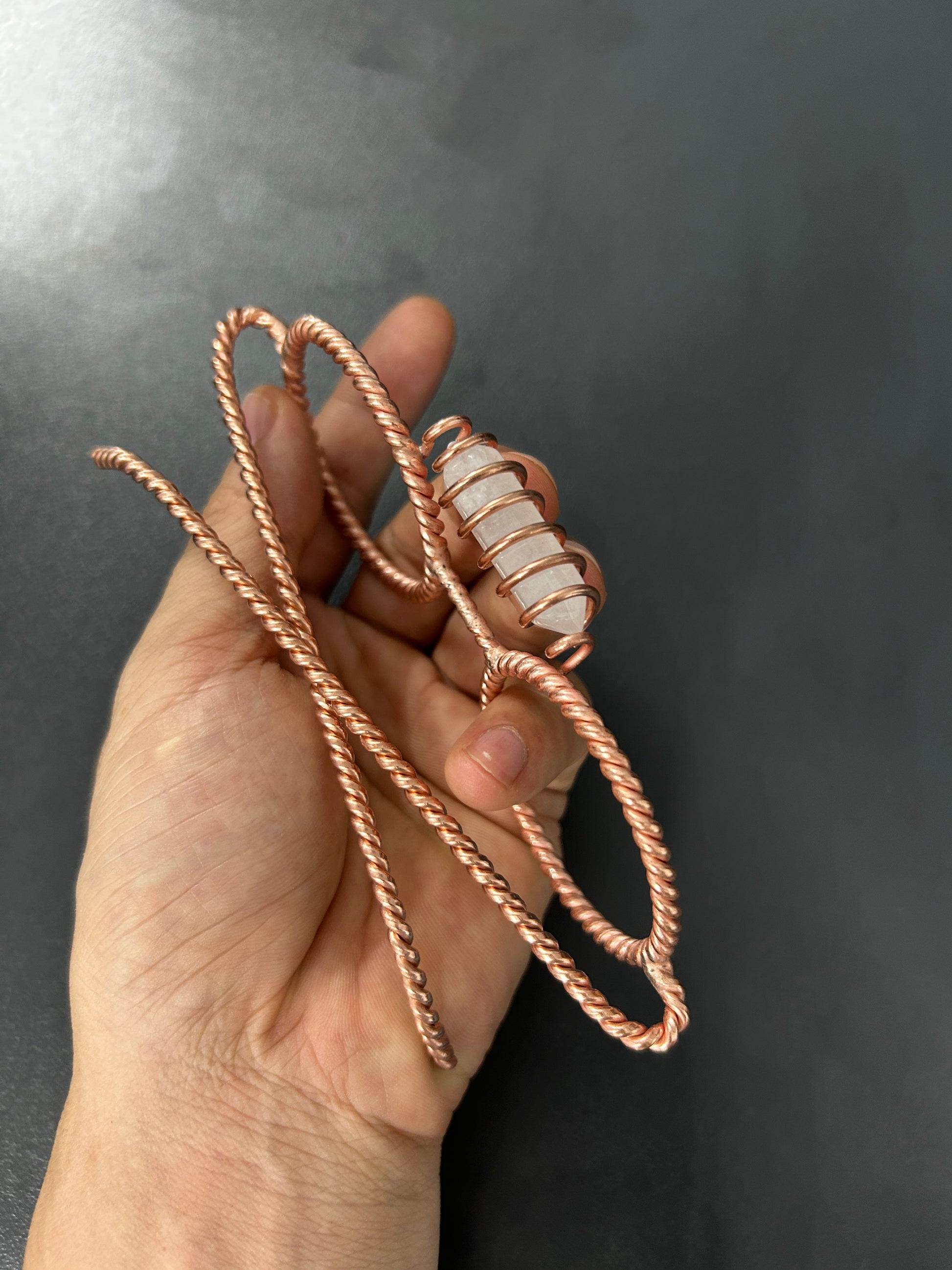 Close up clear quartz crystal copper coil detail on tensor glasses