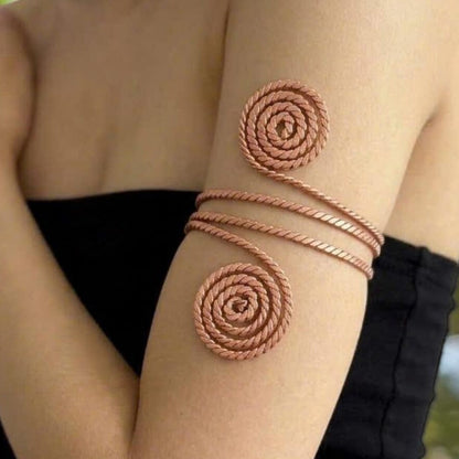Copper spiral coil placed on a forearm, a handmade body coil for relaxation and meditation