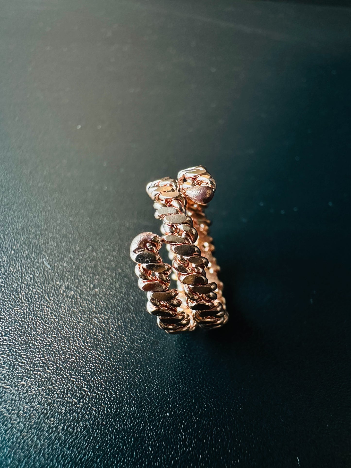 Copper braided ring next to a ruler showing its width and band thickness for sizing reference