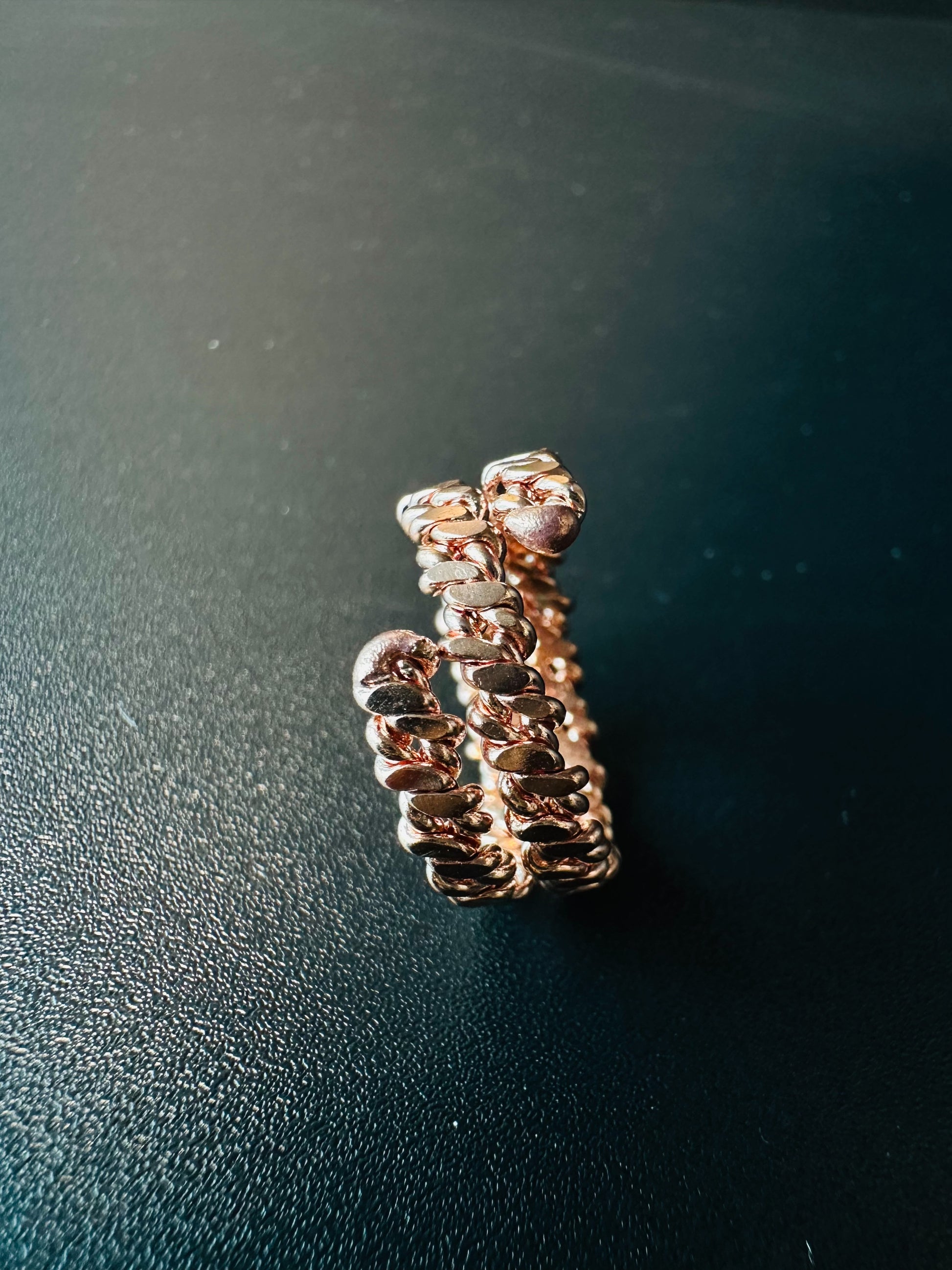 Copper braided ring next to a ruler showing its width and band thickness for sizing reference