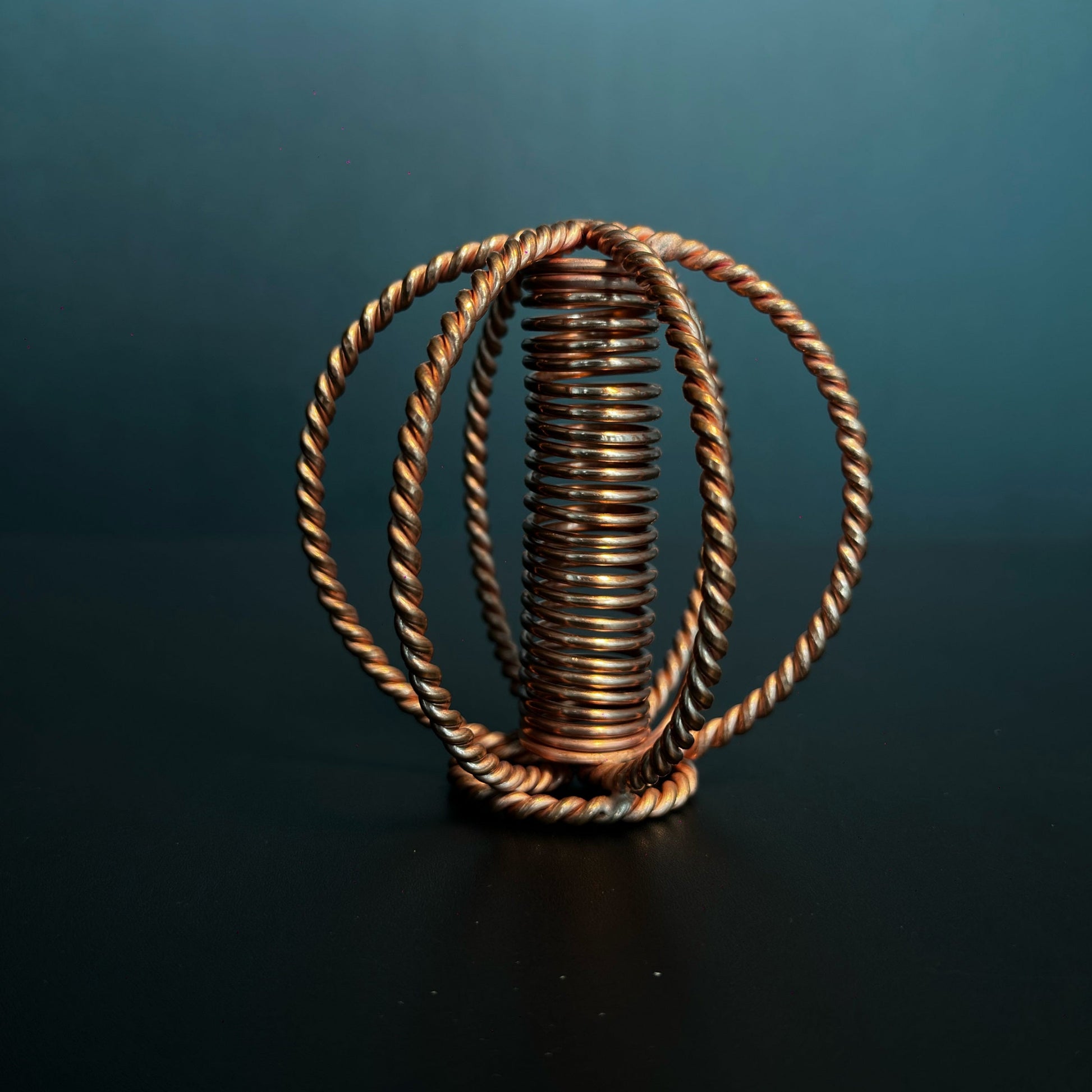 Handmade copper coil sphere with twisted-wire cage and coil core