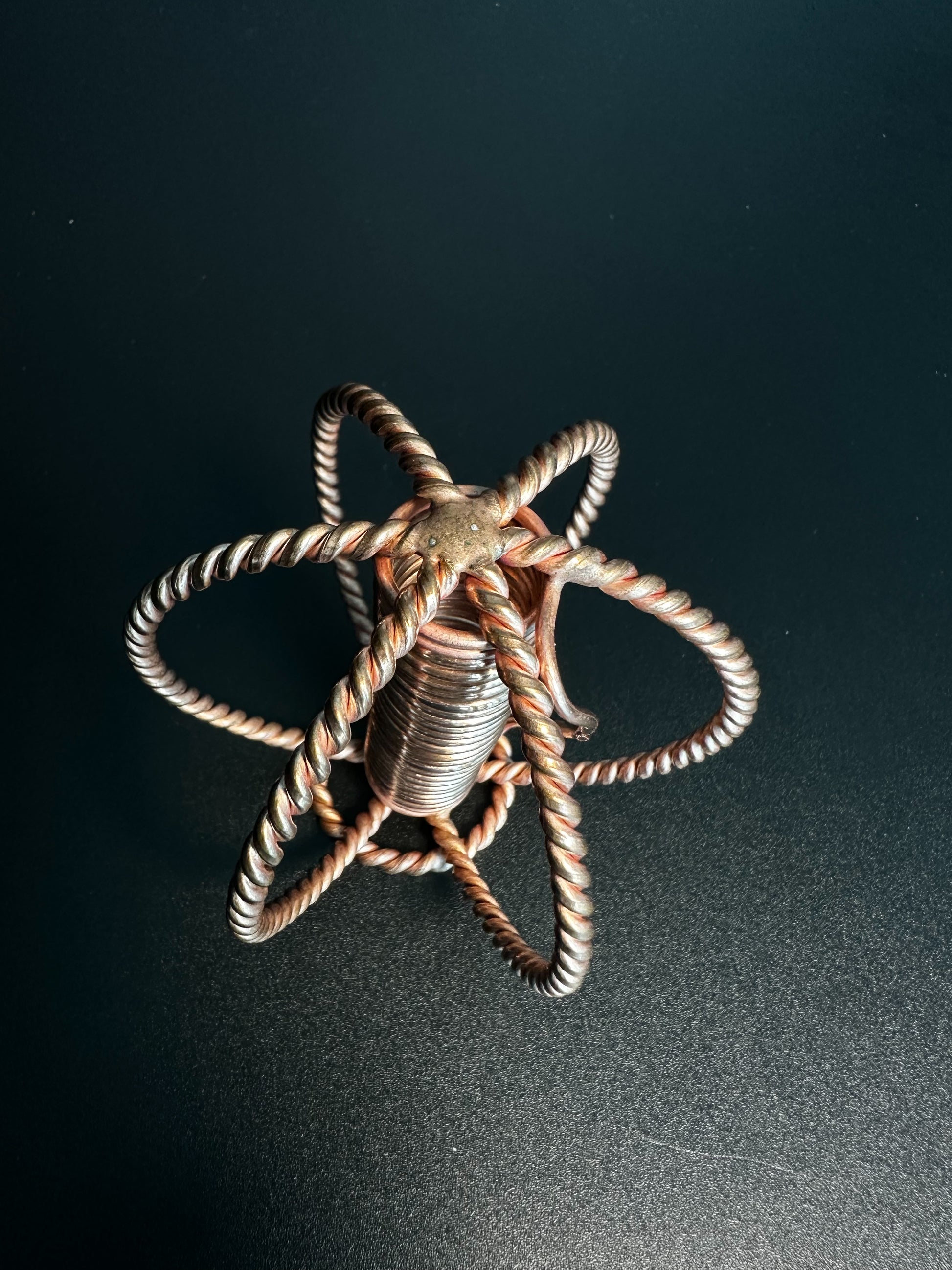 Top view of copper sphere forming a six-petal seed of life