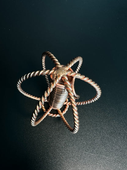 Top view of copper sphere forming a six-petal seed of life