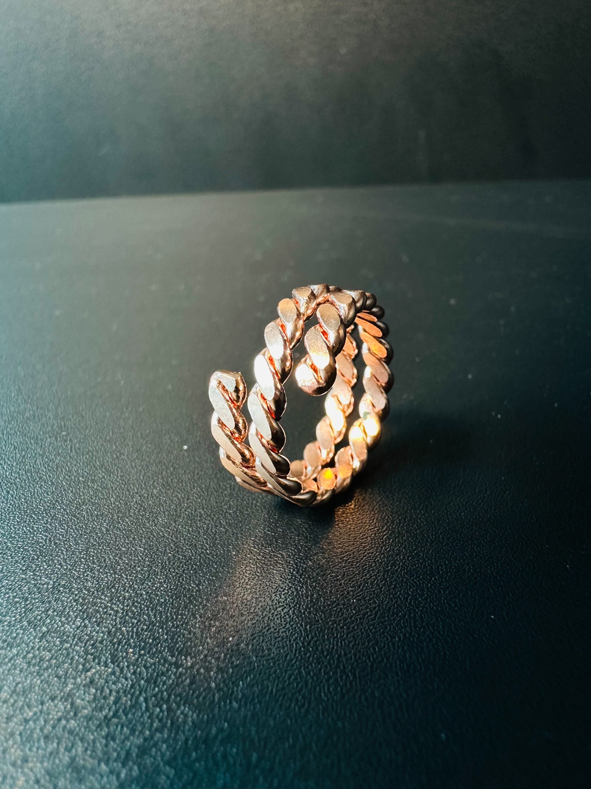 Side view of the chunky copper chain ring showing its thick linked band and polished faces