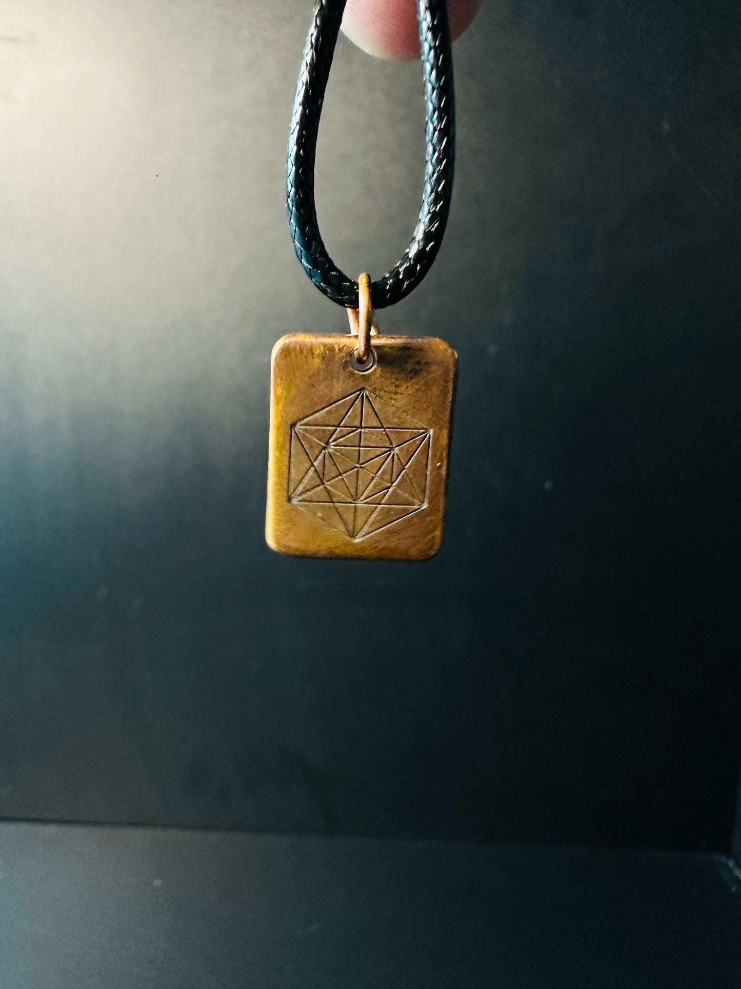 Copper Metatron's Cube pendant hanging on a black cord, sacred geometry piece for meditation wear