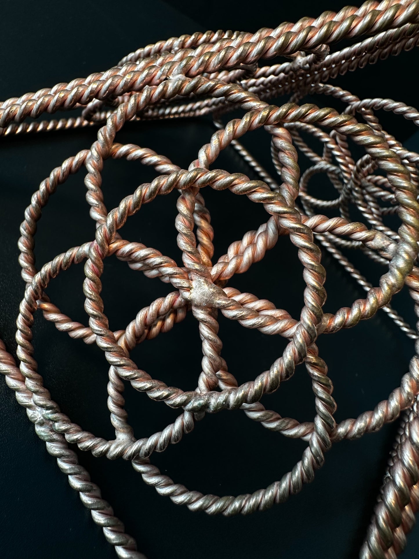 Top view of copper star tetrahedron sacred geometry sculpture