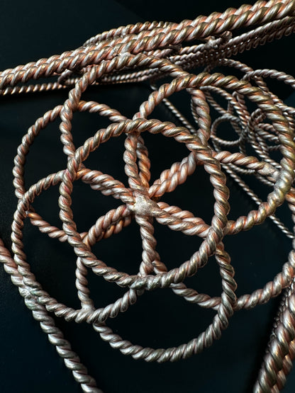 Top view of copper star tetrahedron sacred geometry sculpture