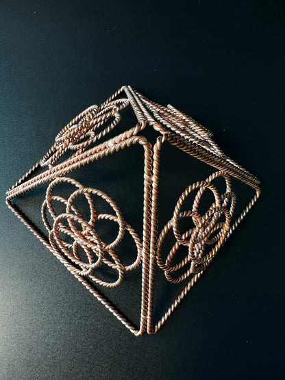 Macro of hand-twisted copper rope wire on a merkaba