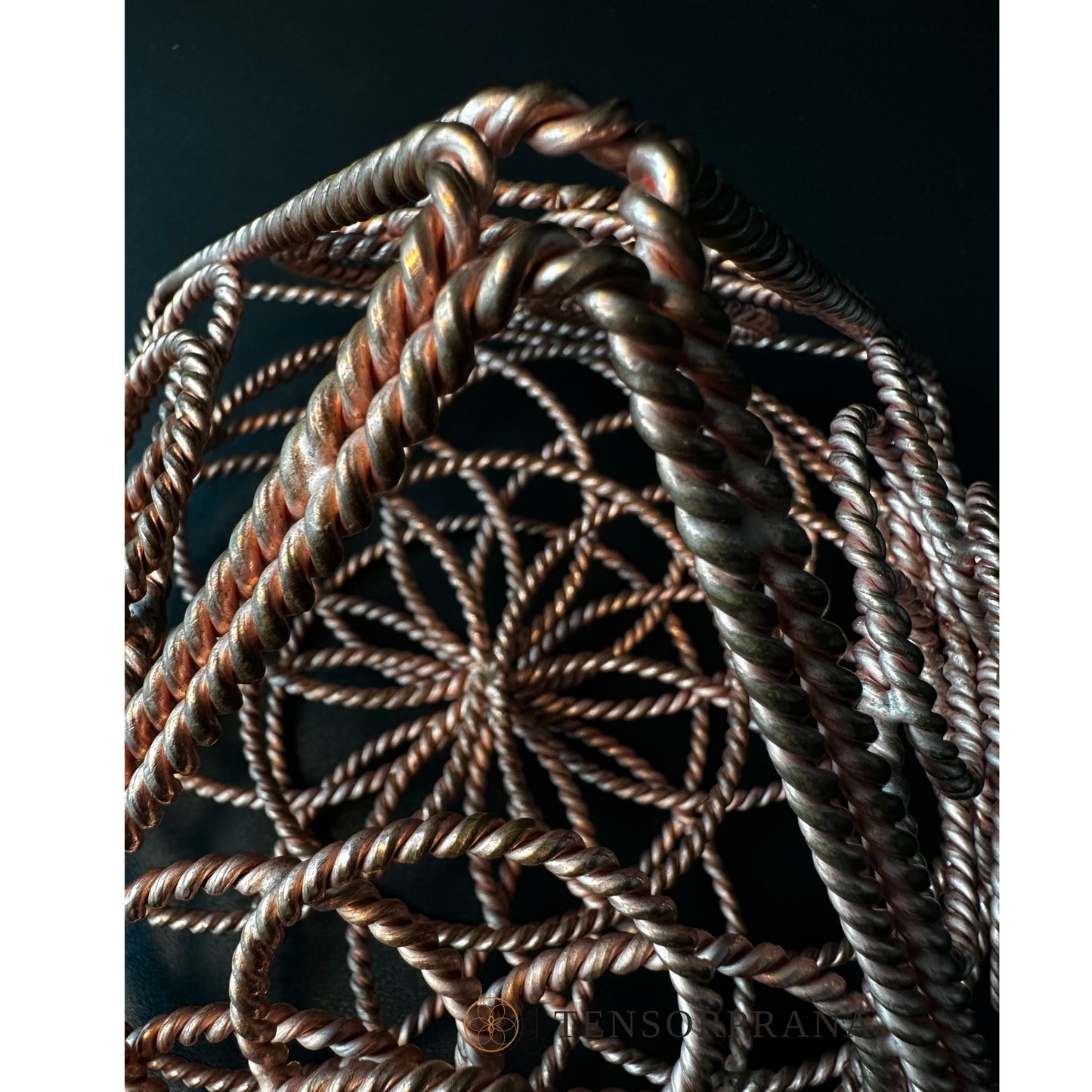 Looking down through the apex of the copper pyramid into its layered wire rings