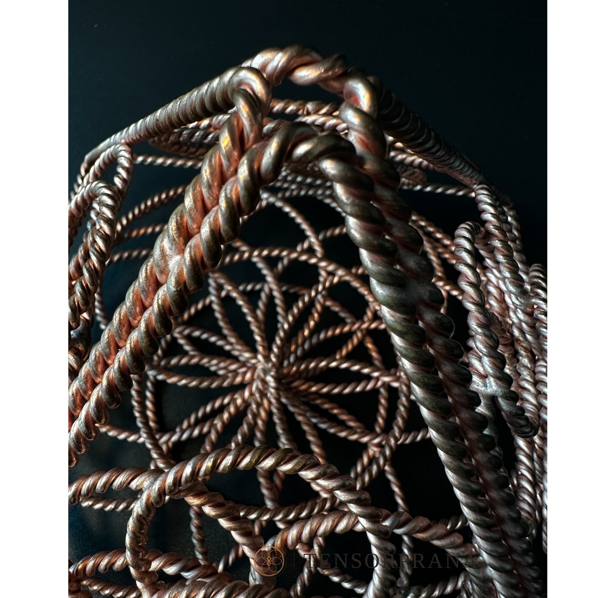 Looking down through the apex of the copper pyramid into its layered wire rings