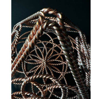Looking down through the apex of the copper pyramid into its layered wire rings