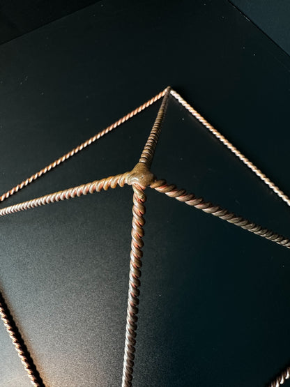 Twisted copper wire edges and soldered corner of pyramid frame