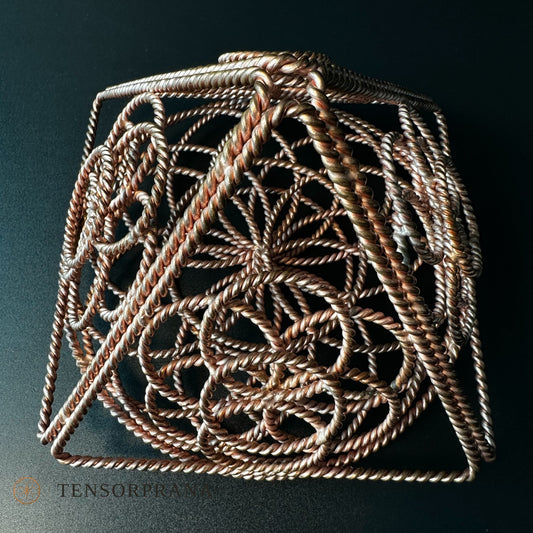 Handmade copper pyramid woven from twisted wire with a Flower of Life pattern inside