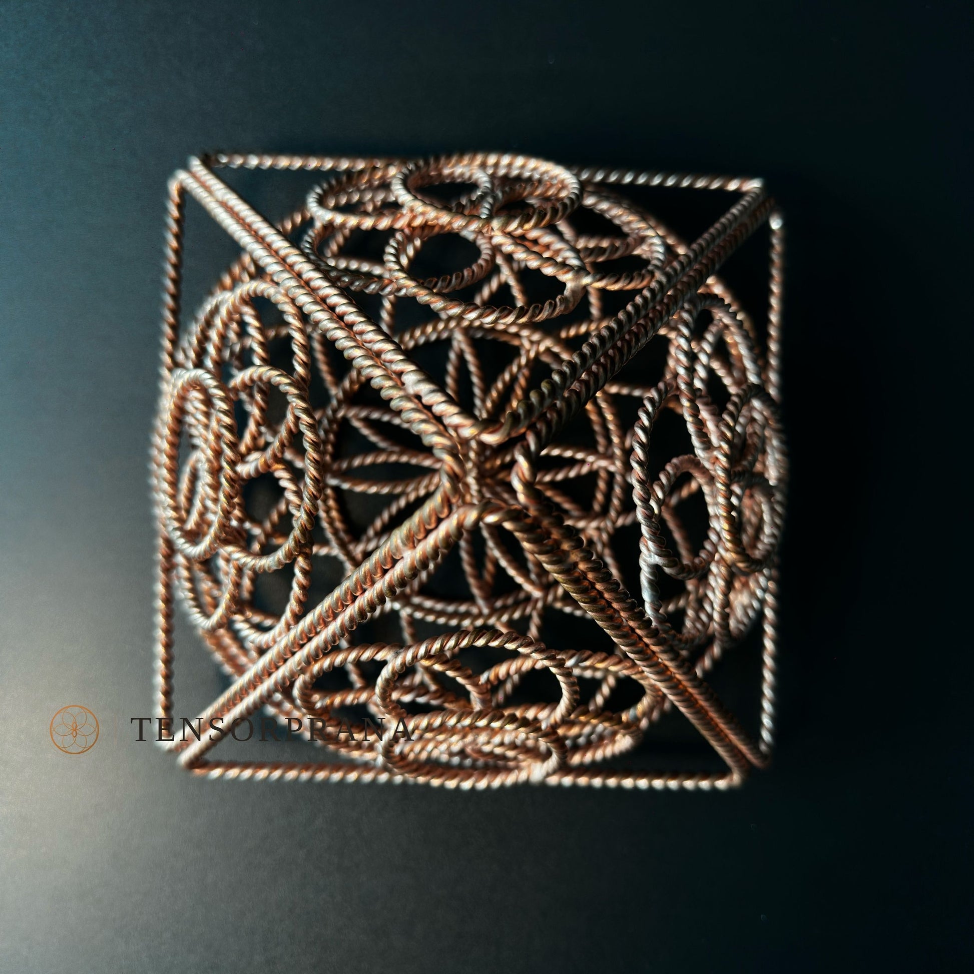 Close-up of the twisted copper wire edges and the Flower of Life weave inside