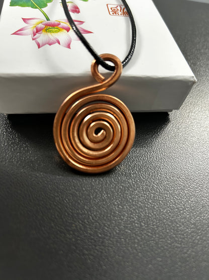 Handmade pure copper spiral coil pendant on black cord, flat vortex sacred geometry necklace on lotus gift box.