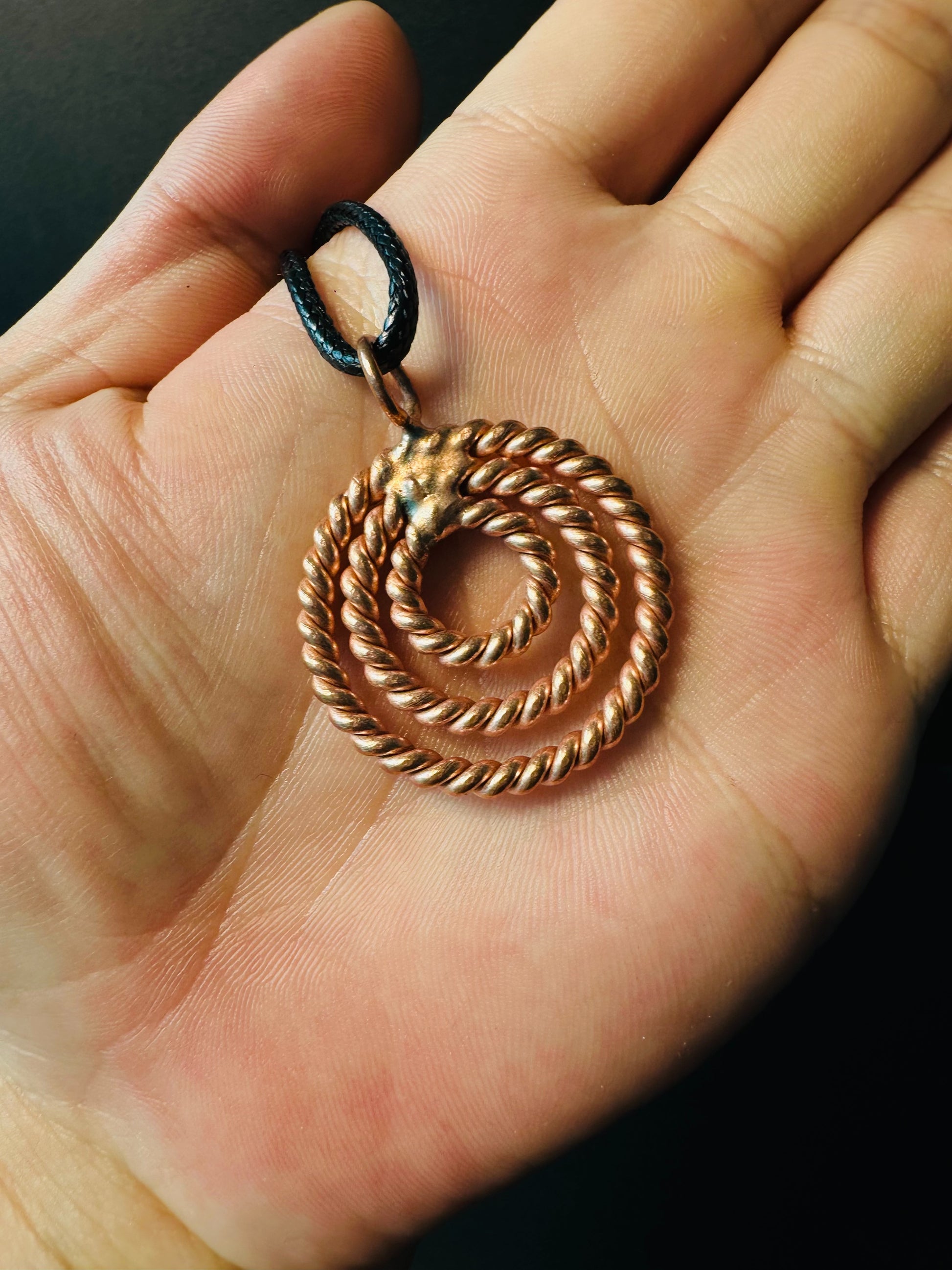 Side view showing rope texture of copper concentric circle pendant