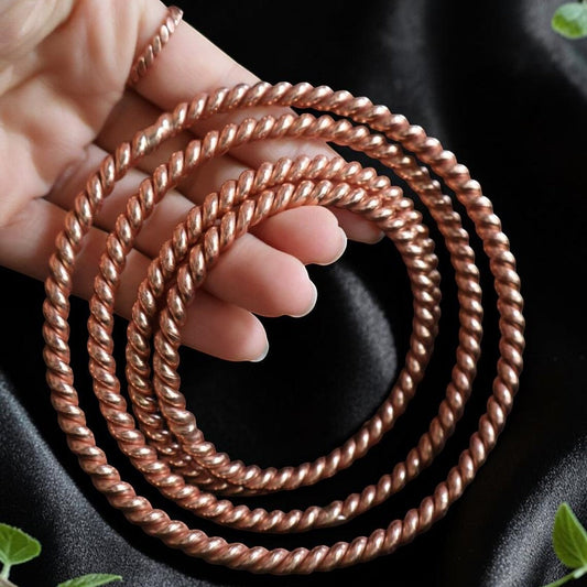 Handmade copper tensor coil with 144, 177, 432 and 528MHz, a flat spiral held in an open hand