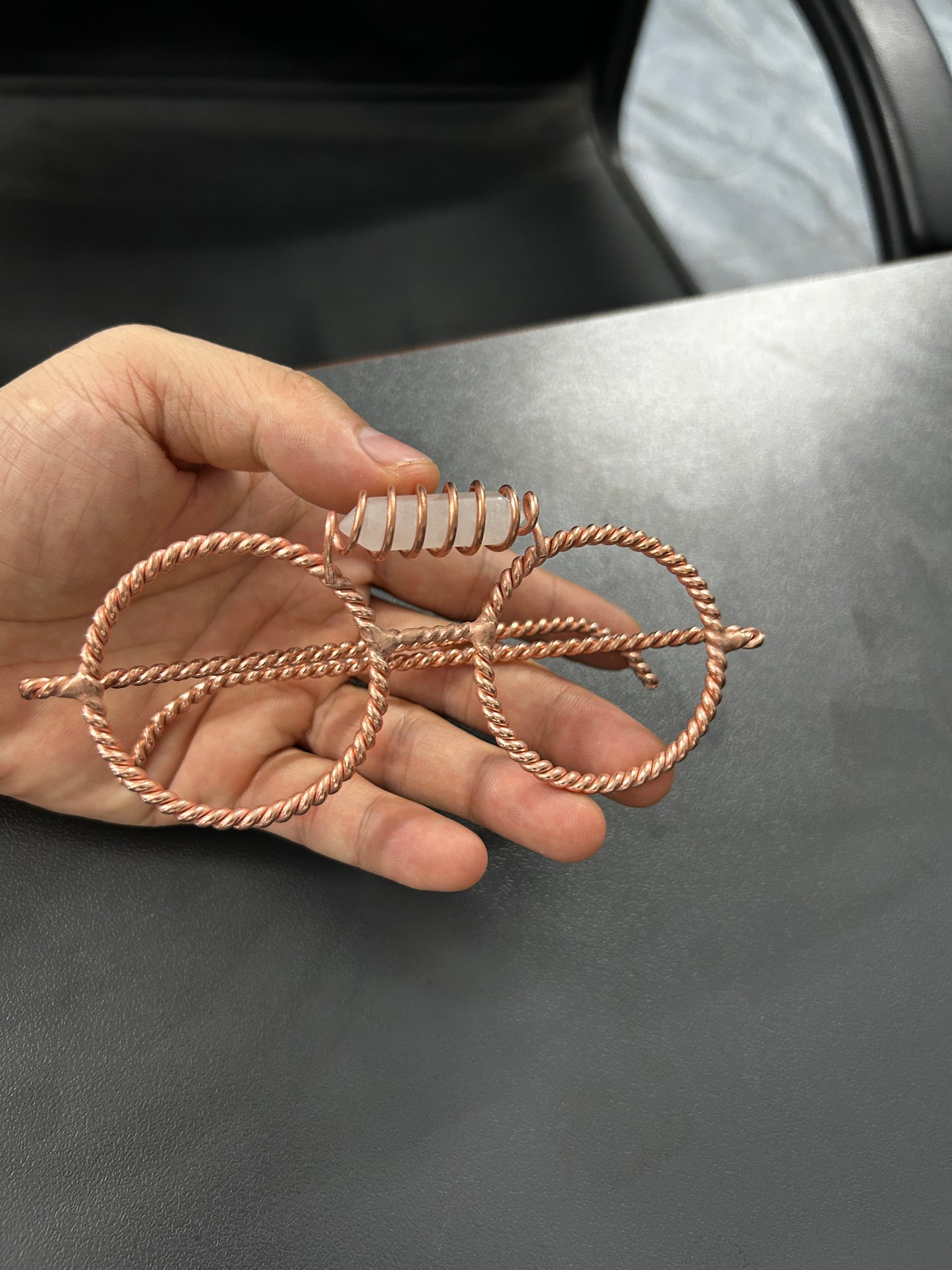 Clear quartz copper tensor glasses held in hand showing size