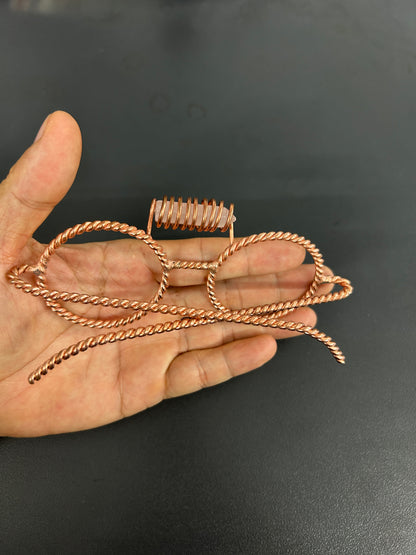 Close up rose quartz crystal coil detail on copper tensor glasses