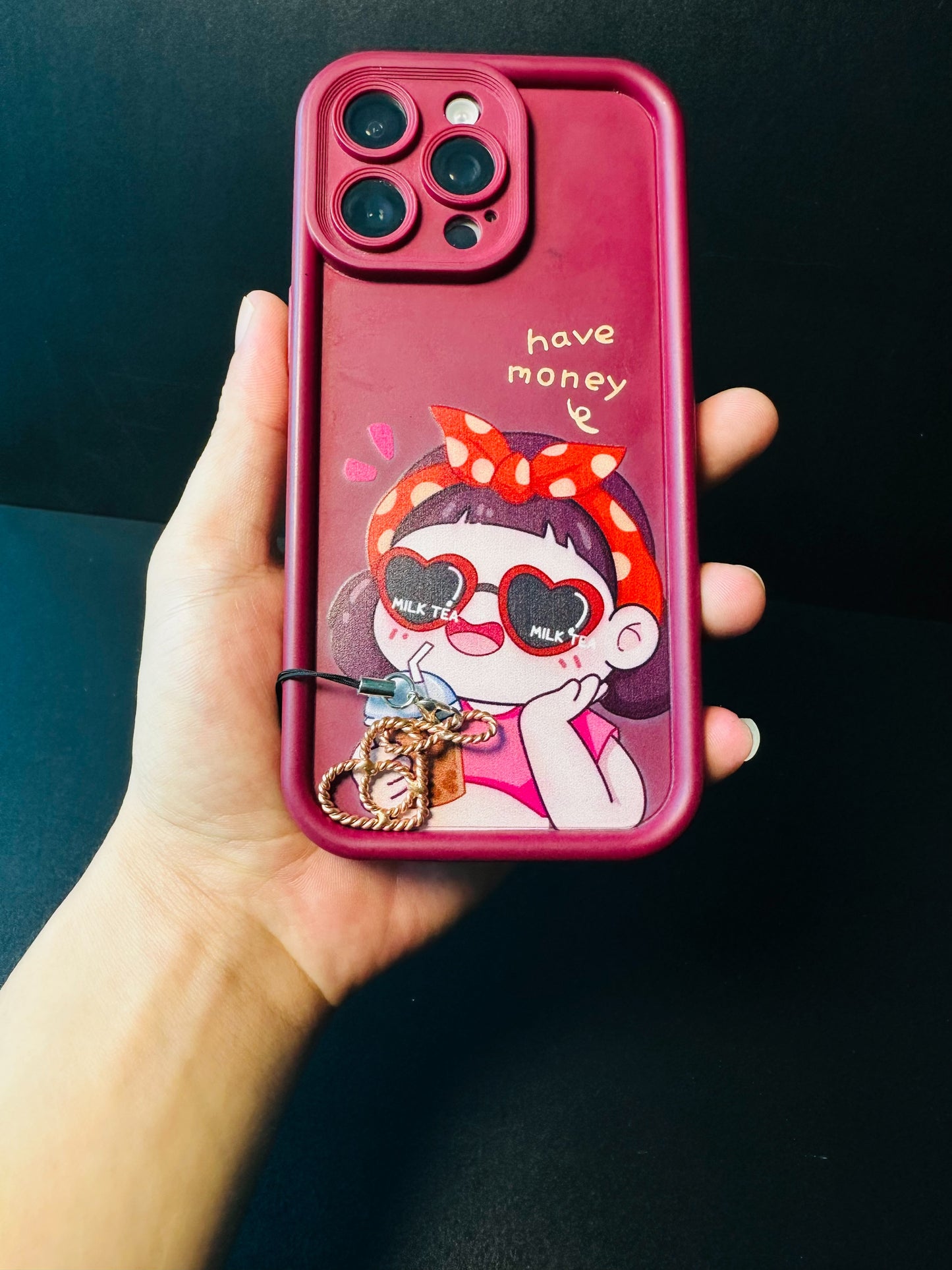 Copper heart phone charm hanging from a phone case, a cute spiritual accessory for everyday carry