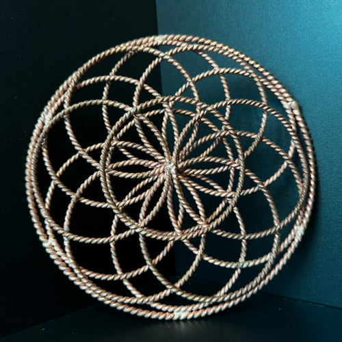 Handmade copper torus sphere woven from twisted rings into a Flower of Life form