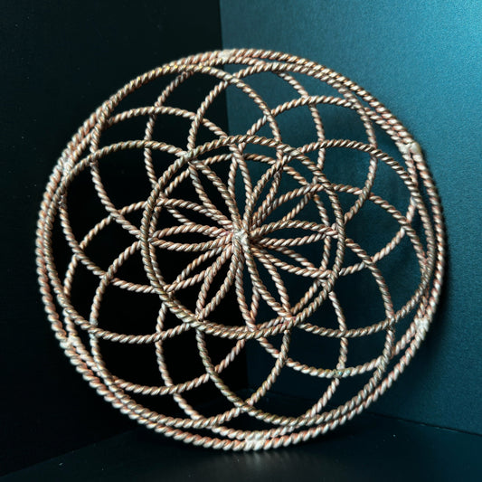 Handmade copper torus sphere woven from twisted rings into a Flower of Life form