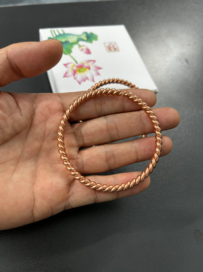 Side view of handmade copper twisted rope bangle showing open adjustable end, solid pure copper cuff.