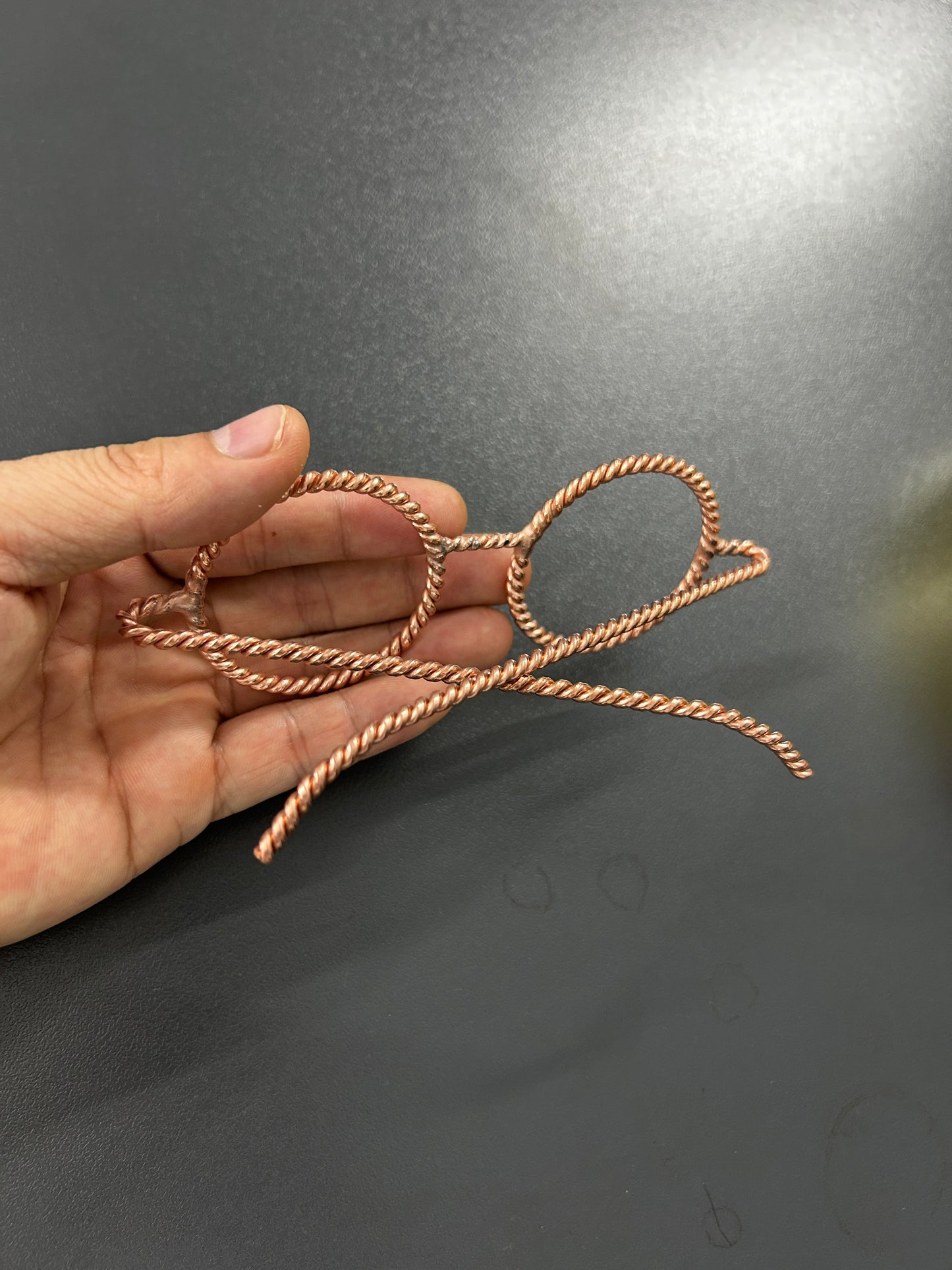 Close up double twisted copper wire detail handmade tensor glasses Vietnam